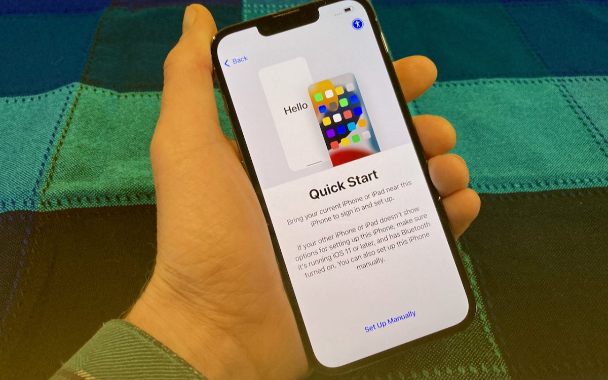 iphone in a man's hand reading an article before transferring data